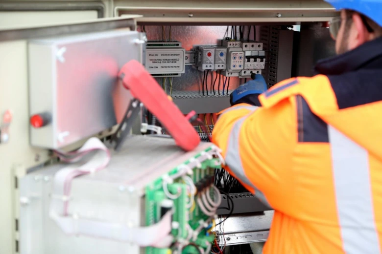 Electrician inspecting panel