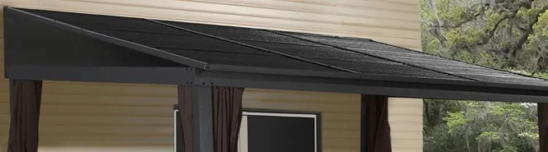 Pergola s průhlednou střešní krytinou na venkovním domě.