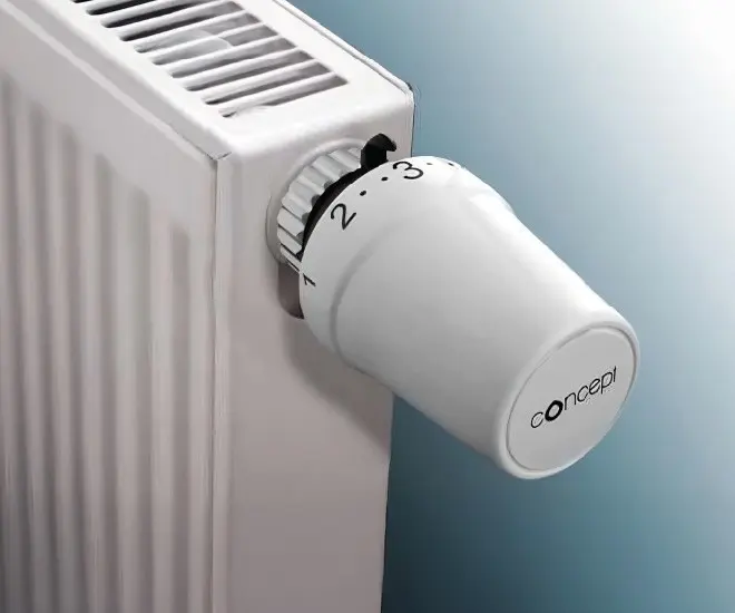 Bílá termostatická hlavice na topení s logem značky Concept.
