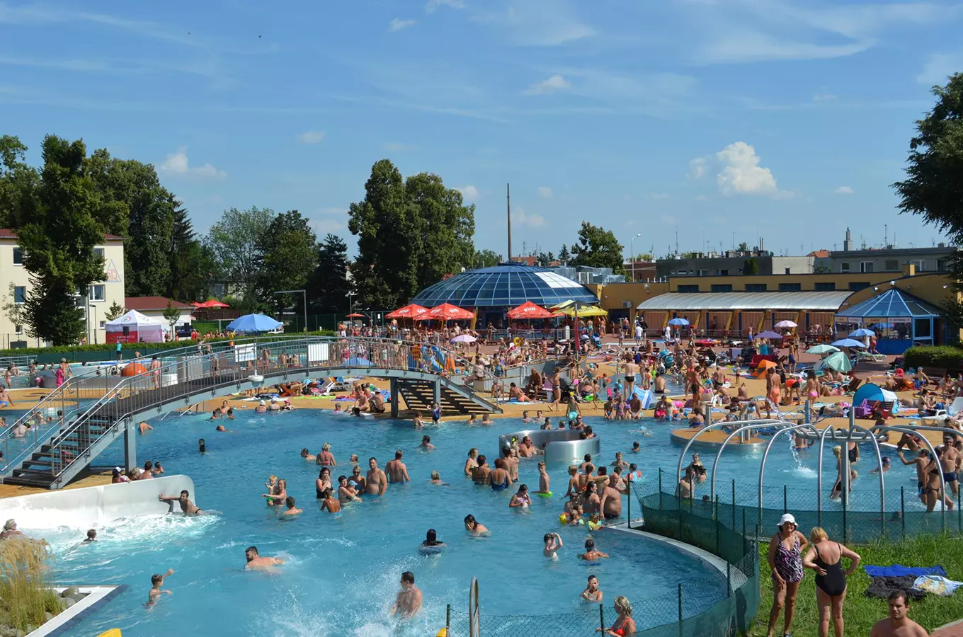 Crowded outdoor swimming pool complex