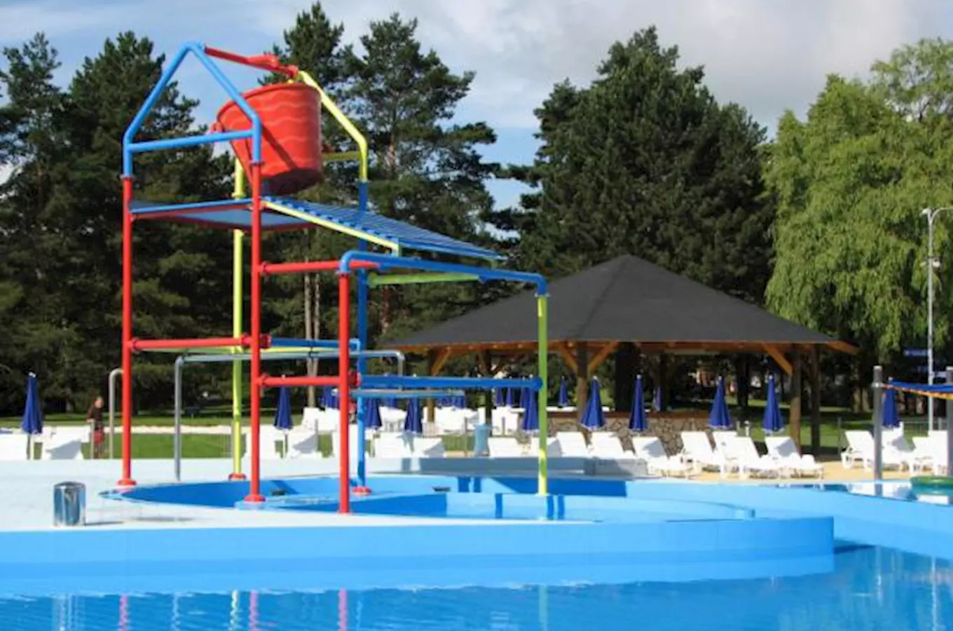 Outdoor swimming pool with play structure