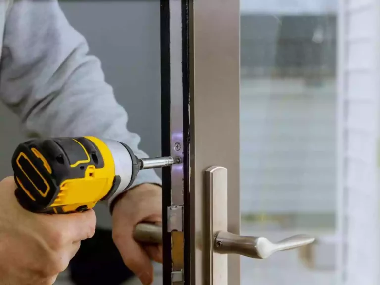 Person repairing door lock with drill