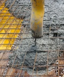 Zalévání betonu na ocelovou výztuž v procesu stavebního díla.