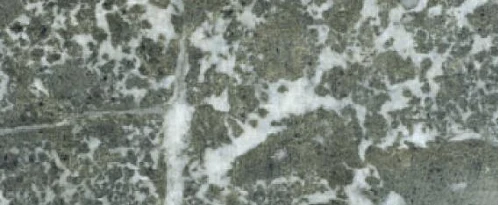 Detailní záběr na povrch stavebního pískovce s přírodními vzory.