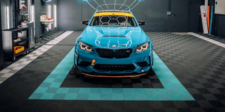 Blue car on garage tiles