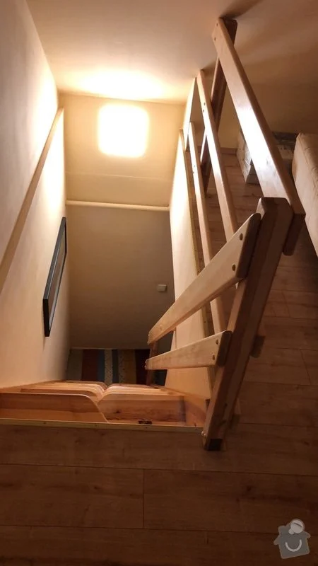 Dřevěné schodiště s dřevěným zábradlím v interiéru.