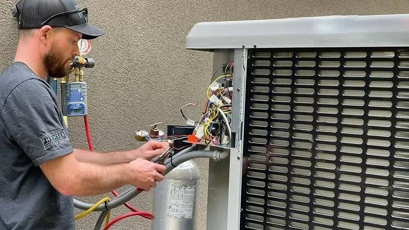 Man servicing pool heater