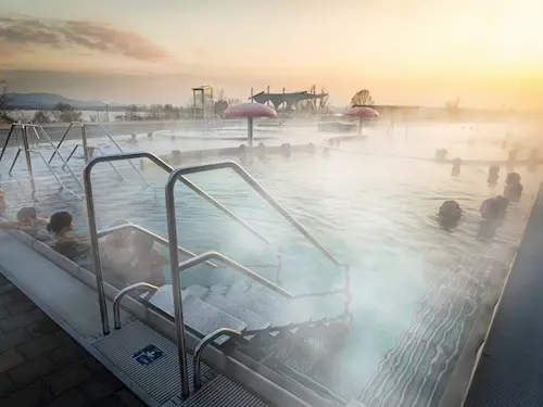 Outdoor thermal pool at sunset