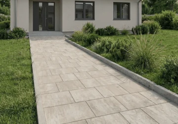 Moderní dům s příjezdem z betonových dlažebních kostek.